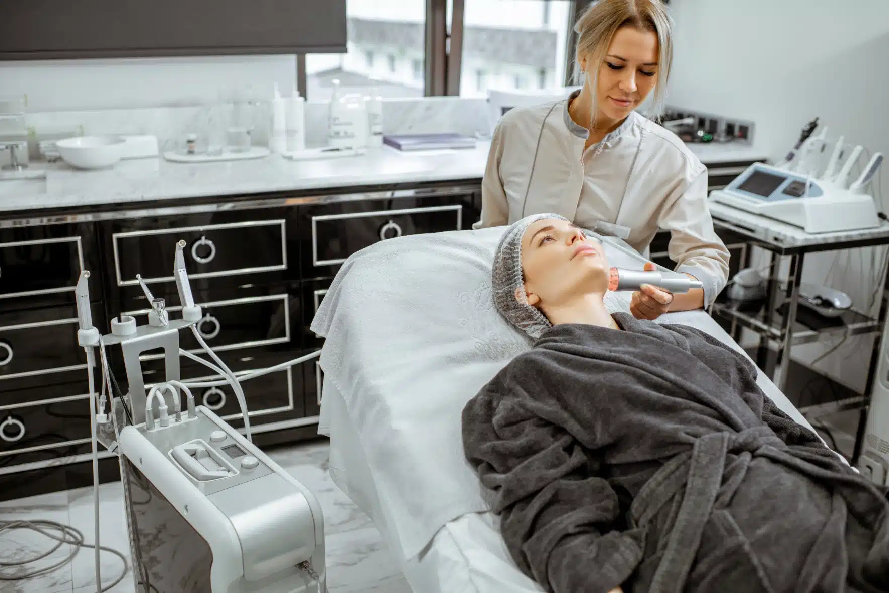 Cosmetologist making facial treatment to a woman facial improvements